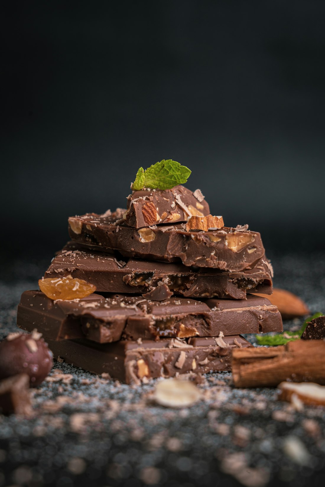 Pieces of dark chocolate stacked on a board