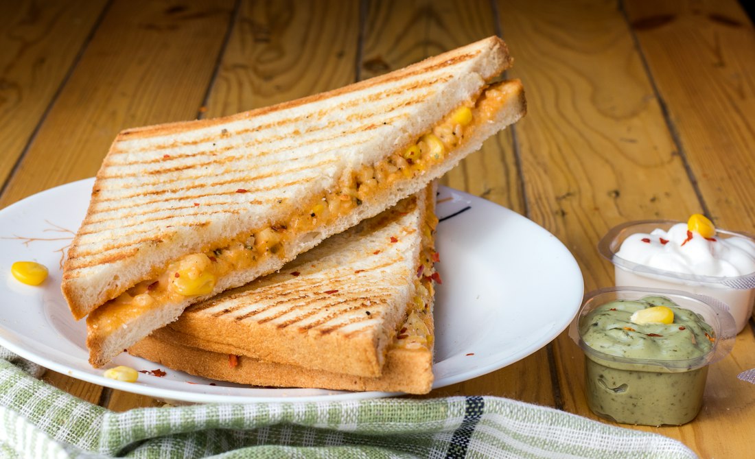 Golden grilled toastie cut in half on a plate